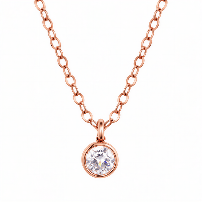 Rose gold chain necklace with a round clear stone in a bezel setting.