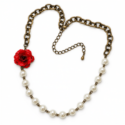 Bronze chain necklace with a red rose charm and a string of white round pearls on a white background.