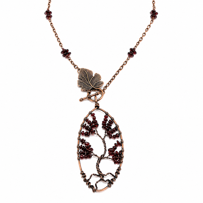Copper wire tree of life pendant with red garnet beads on a matching chain with a leaf-shaped toggle clasp.