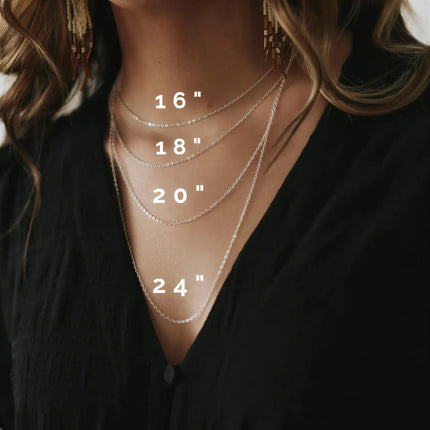 Four silver metal chain necklaces of varying lengths layered on a person, labeled with 16, 18, 20, and 24 inch text.